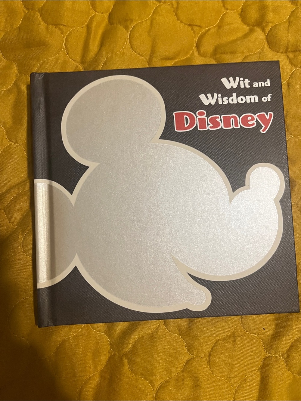Disney Hardcover Book with Silver Mickey Silhouette on Black and Red Logo